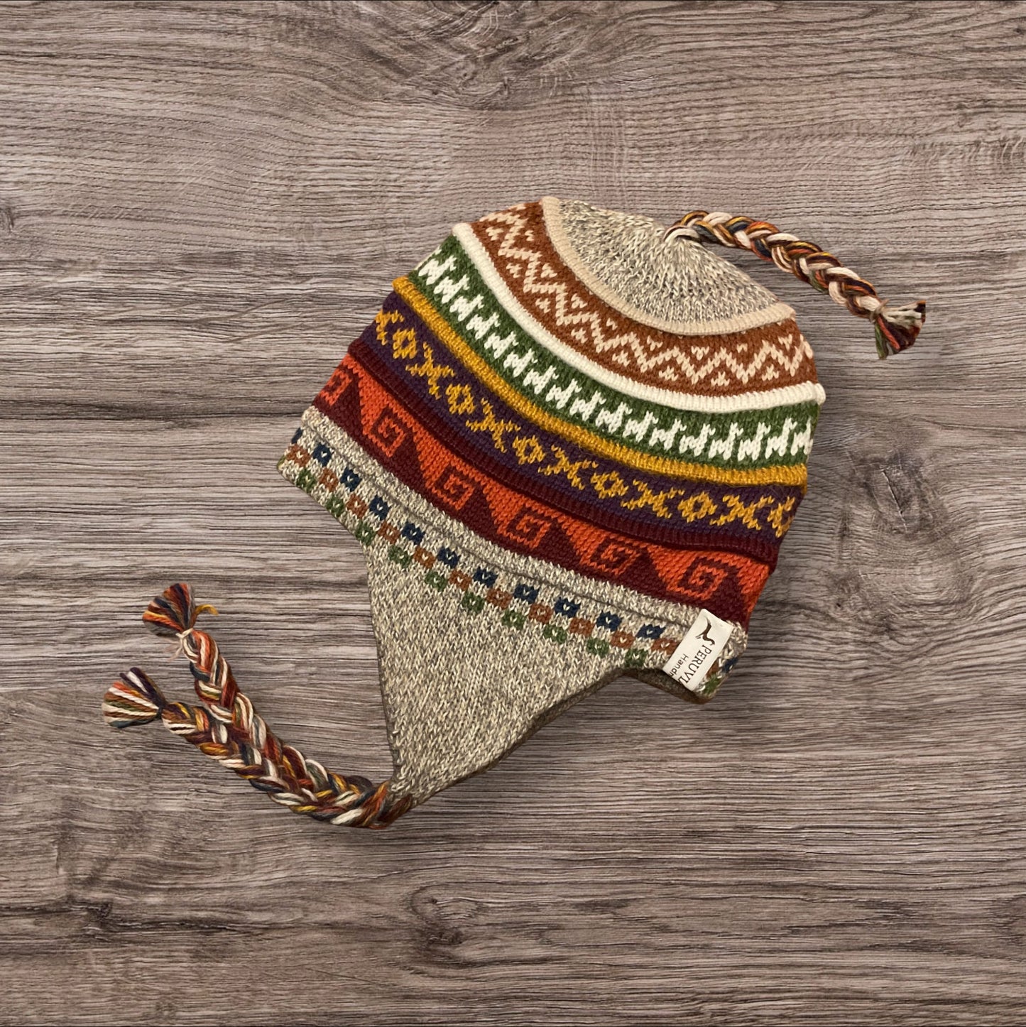 Oatmeal color, reversible, luxury alpaca chullo beanie. hypoallergenic, repels water, wicks moisture and regulates heat.  Super soft and so fun for snowboarding, skiing, hiking and travels.  Style #14. By Peruvian Accent