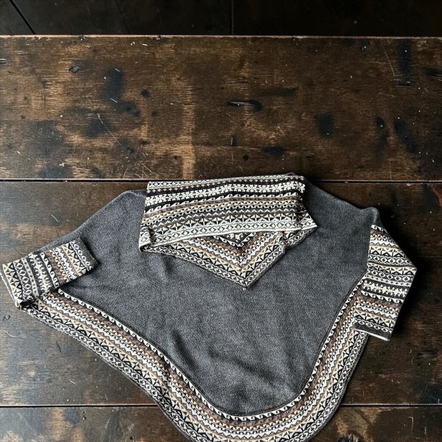 Peruvian Accent charcoal grey alpaca poncho with sleeves and a patterned cowl neck and cuffs.
