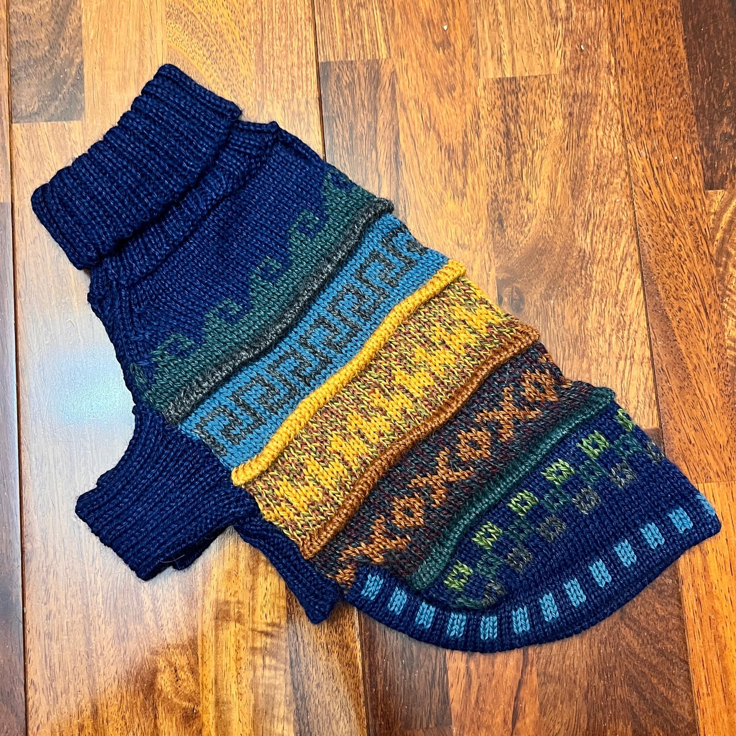 Peruvian Accent navy blue quarter sleeve dog sweater with colorful Andean patterns, made of alpaca wool.