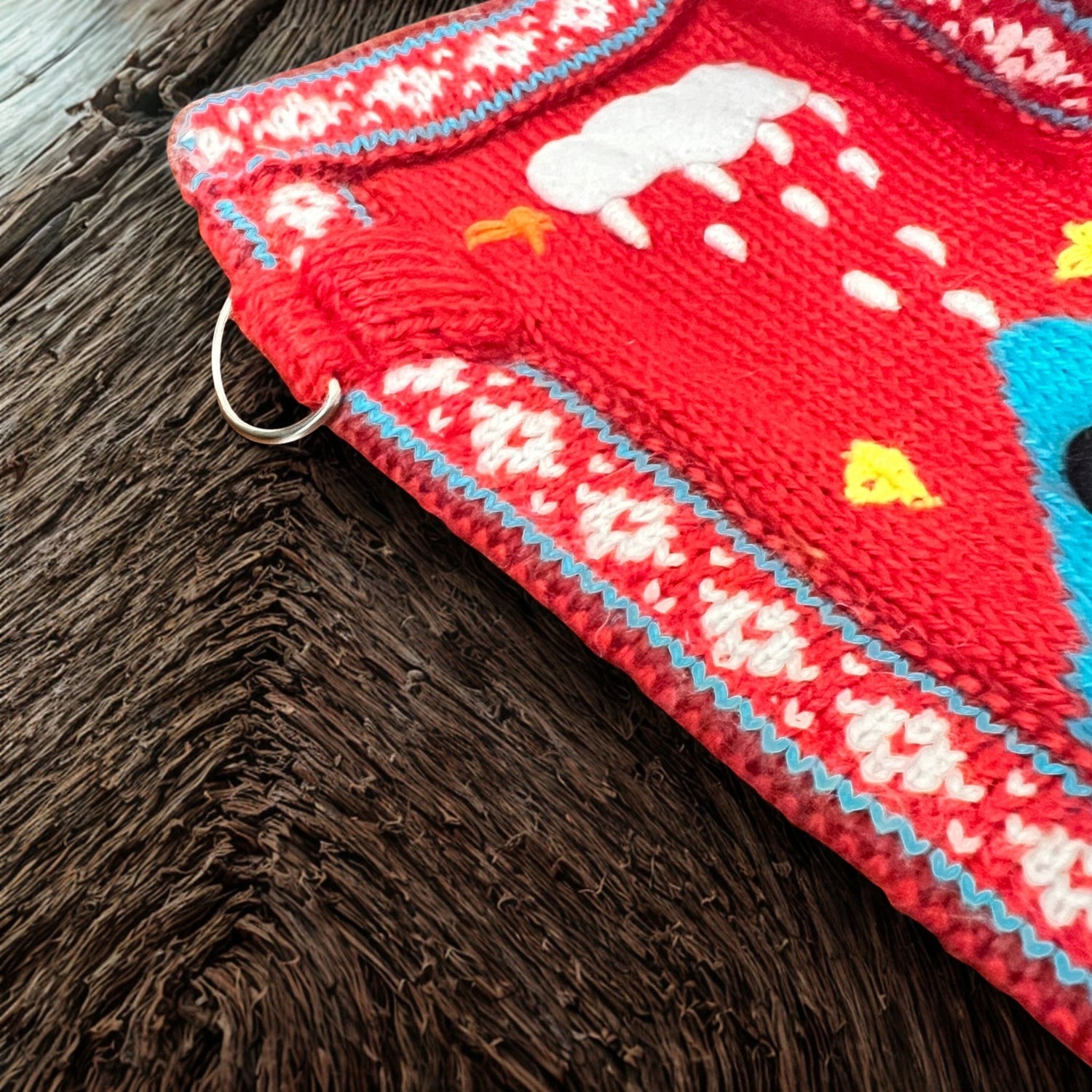 Peruvian Accent red alpaca dog sweater with Nazca-inspired holiday designs including snowmen, snowflakes, and reindeers.