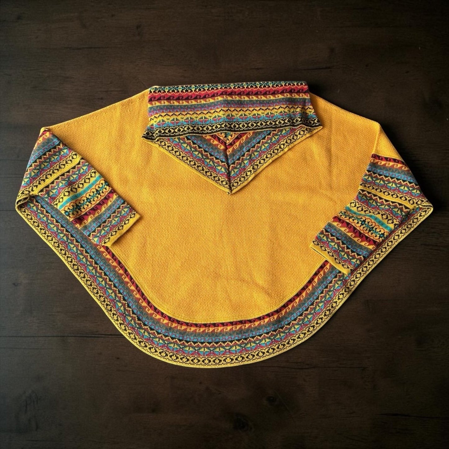 Peruvian Accent yellow alpaca poncho with sleeves and colorful geometric trim. Cowl neck.